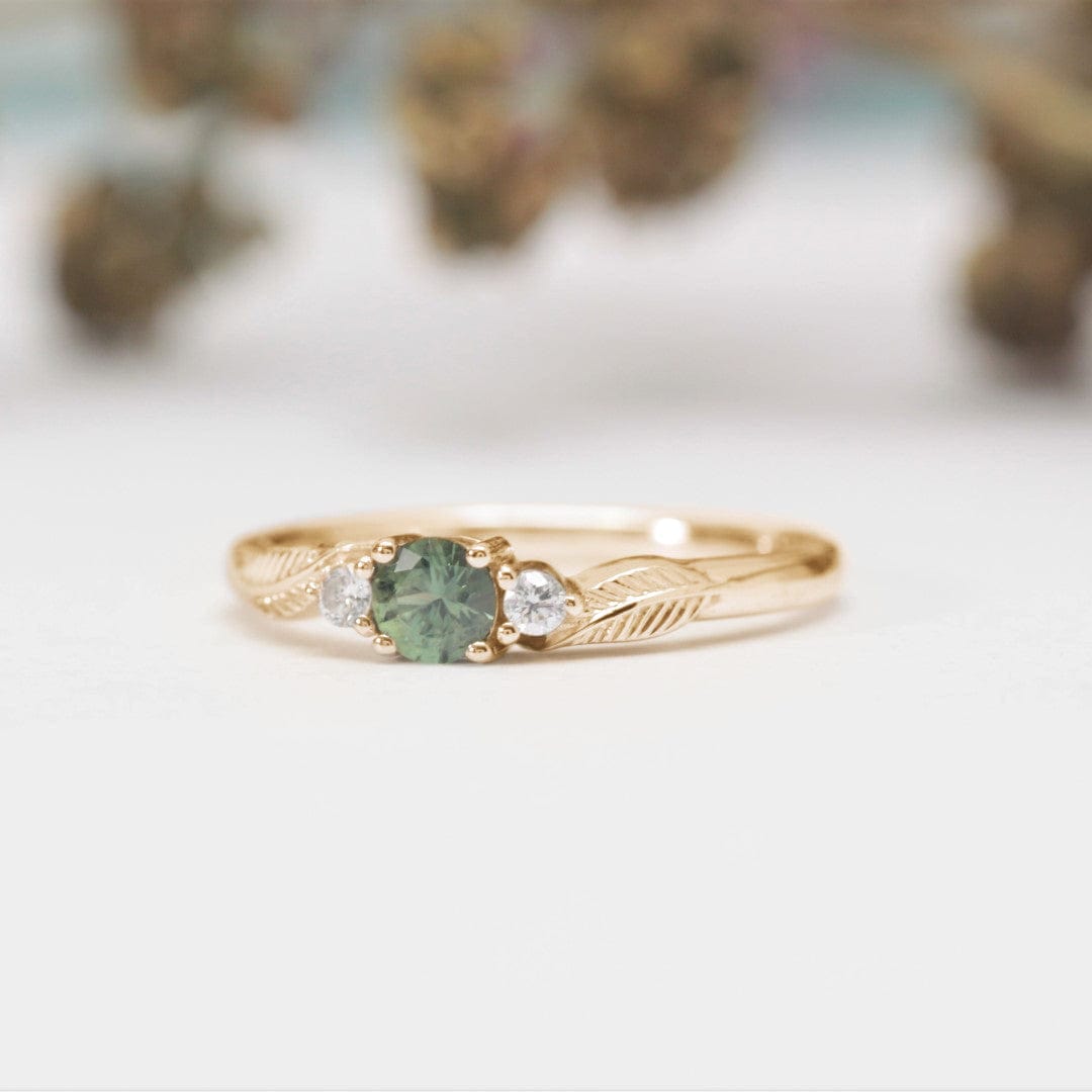 green sapphire and diamond leaf engagement ring yellow gold