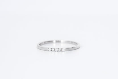 thin diamond wedding band with 5 small diamonds in white gold