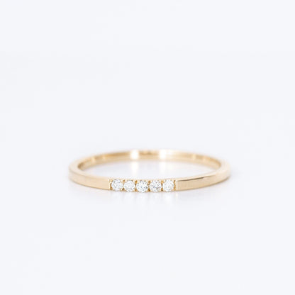 thin diamond wedding band with 5 small diamonds in yellow gold