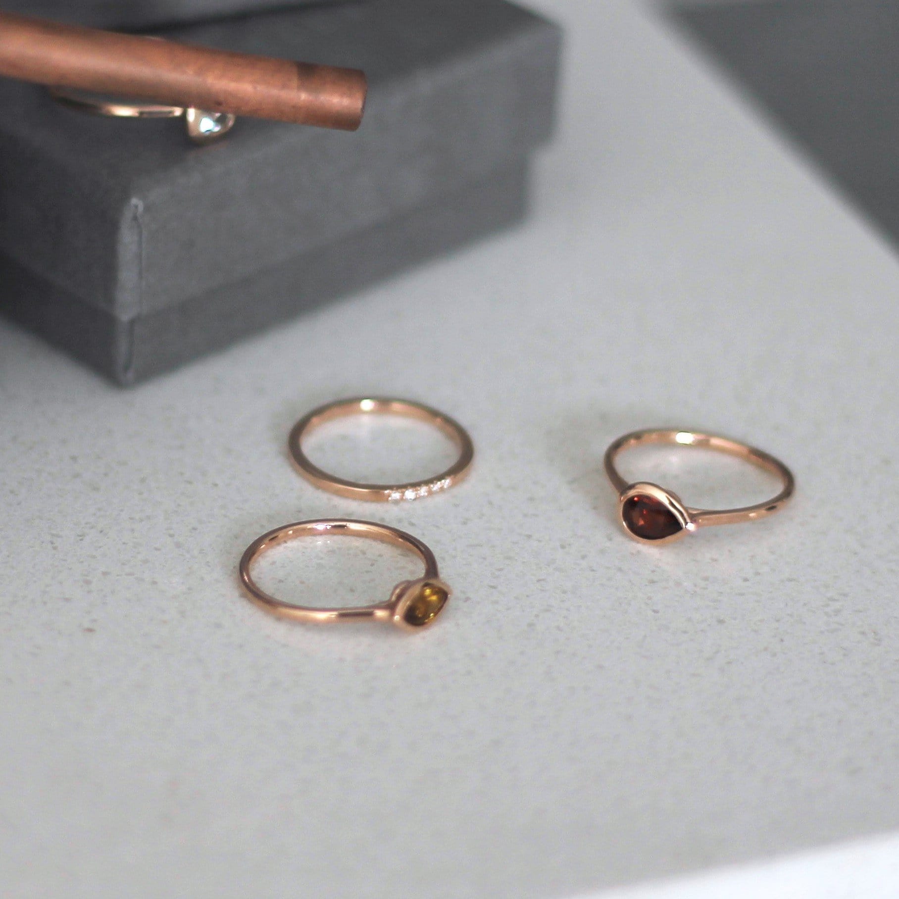 thin diamond wedding band with 5 small diamonds in rose gold